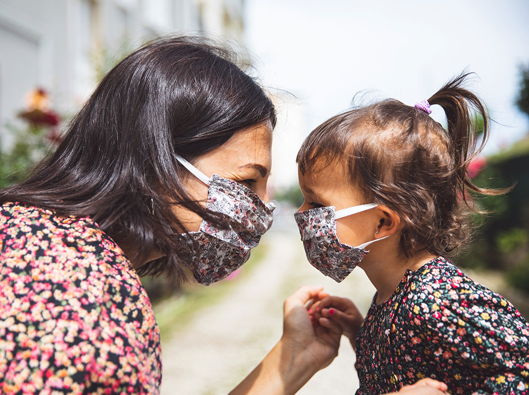 mom and young daughter wearing masks