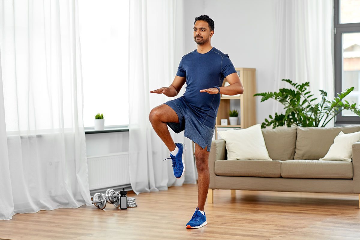 Man running with high knees during an at-home workout