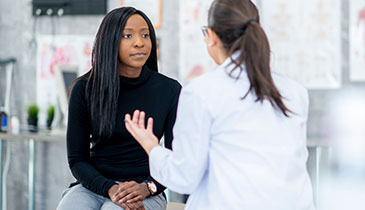 provider speaking with adult female patient
