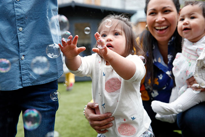 family playing with bubbles
