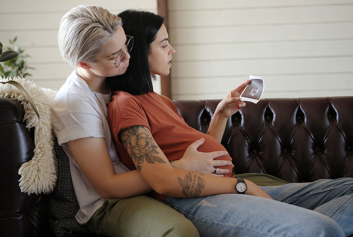 LGBTQ+ couple looking at a sonogram image