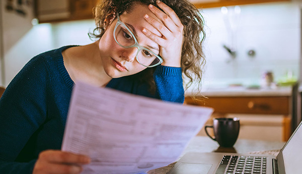 woman looking at bill feeling stressed