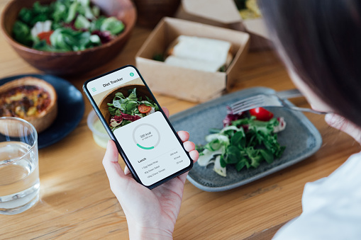 Image of healthy eating and a phone showing an app