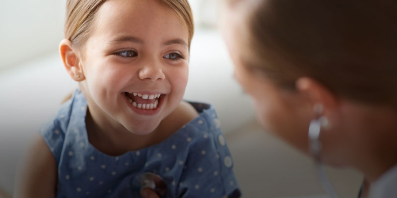 child smiling during physical exam