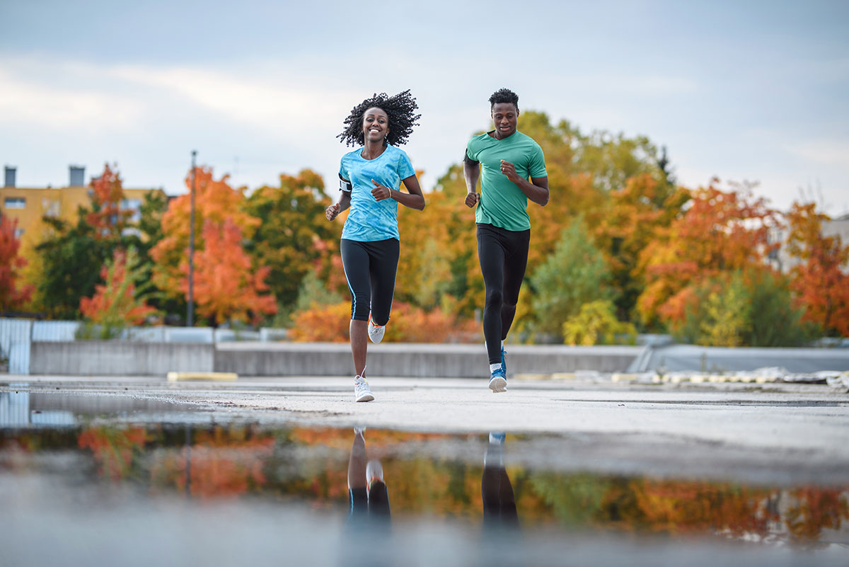 man and woman couple running outside for exercise