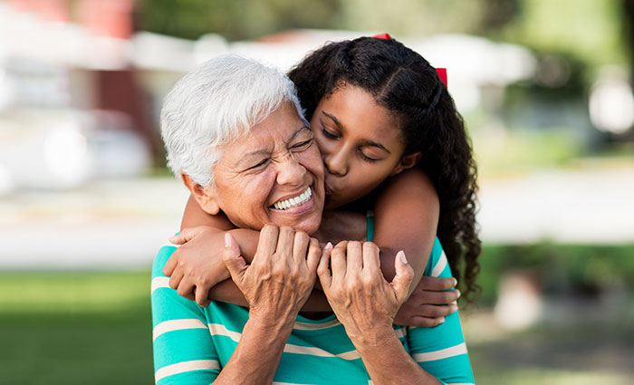 granddaughter giving grandma a hug