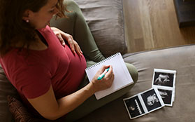 pregnant woman taking notes