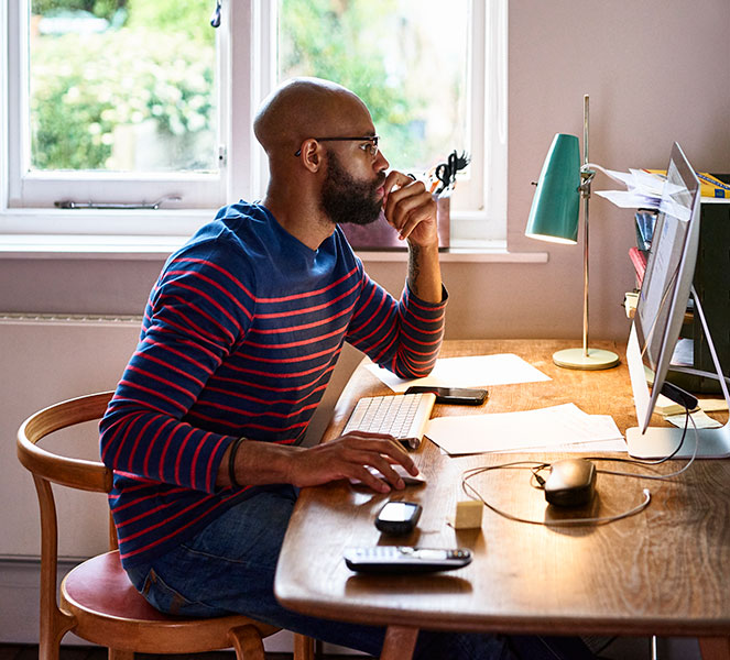 man on computer in home office