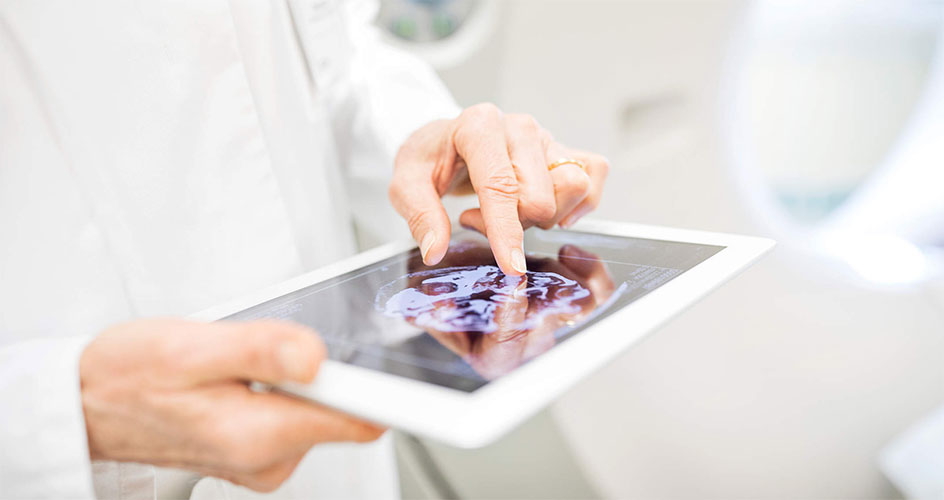 doctor looking at imaging on tablet
